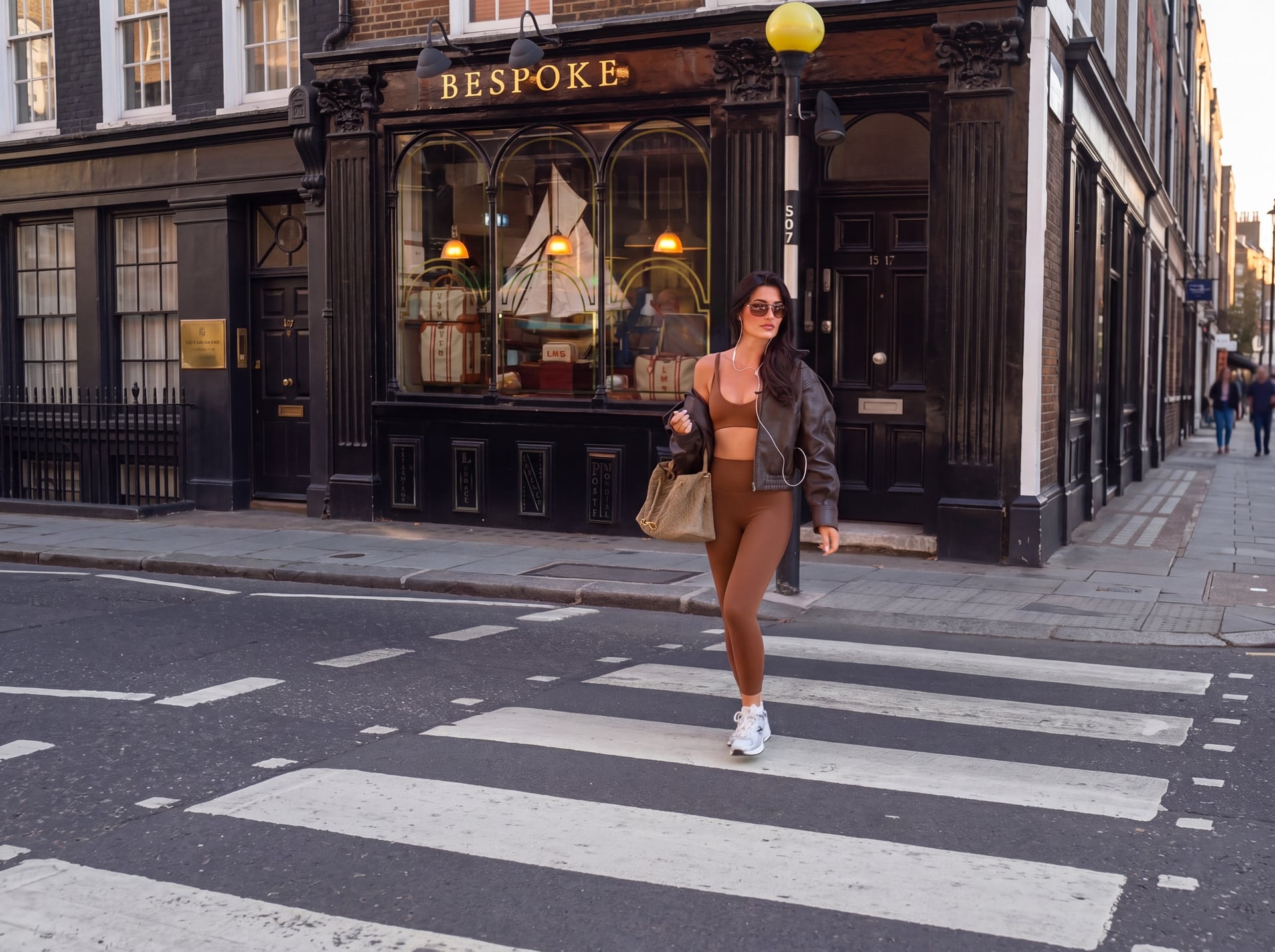 Woman wearing the HHARA collection walking by a G-Wagon